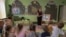 A teacher leads a class about mine safety in a kindergarten in Kryvyi Rih, Ukraine, Sept. 14, 2023. Teachers, along with civil servants and pensioners, could see delayed pay if Western aid to the country is not approved soon, officials say. 