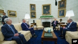 Senate Minority Leader Mitch McConnell, left, Speaker of the House Kevin McCarthy, second from left, and Senate Majority Leader Senator Chuck Schumer, right, listen to U.S. President Joe Biden in the White House in Washington, May 9, 2023.