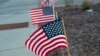 (FILE) American flags placed along a sidewalk