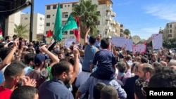 Protesters gather for a show of solidarity with Palestinians in Gaza, near Israel's embassy in Amman, Jordan, Oct. 7, 2023.