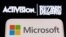FILE: Microsoft logo is seen on a smartphone placed on displayed Activision Blizzard logo in this illustration taken January 18, 2022. 