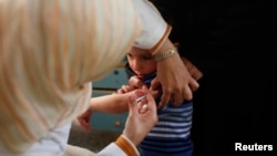 FILE - A Palestinian boy receives polio vaccine at a hospital in Khan Younis in the southern Gaza Strip, Feb. 23, 2014. The health ministry in Hamas-run Gaza declared the Palestinian territory to be a "polio epidemic zone" on July 30, 2024.