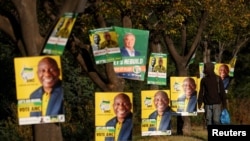 A man walks past election posters of the ruling African National Congress (ANC), as South Africa prepares for the May 29 general elections, in Soweto, May 24, 2024. 