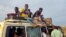 Peolpe displaced from Sudan's Jazira state arrive in packed vehicles to the entrance of the eastern city of Gedaref, Sudan, on June 10, 2024