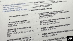The indictment in Georgia against former President Donald Trump is photographed Monday, Aug. 14, 2023. (AP Photo/Jon Elswick)