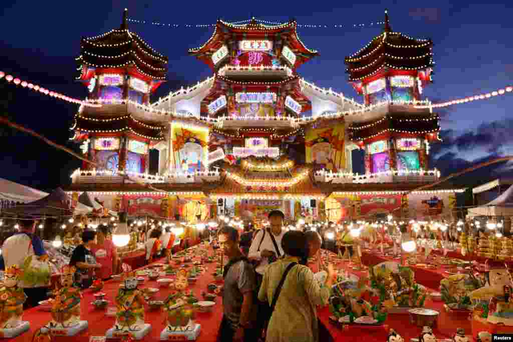 People prepare for the annual Hungry Ghost Festival prayer in Keelung, Taiwan.