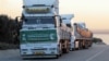 Aid trucks from Saudi Arabia line up at the border crossing from Turkey to Syria in the aftermath of an earthquake, Feb. 11, 2023.