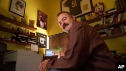 FILE - Former Chicago Bears linebacker Dick Butkus is surrounded by football memorabilia at his home in Malibu, Calif., Jan. 6, 2000. Butkus died Oct. 5, 2023, at his home. He was 80.