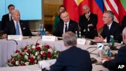 President Joe Biden, Polish President Andrzej Duda and others, listen as NATO Secretary General Jens Stoltenberg speaks during a meeting with the leaders of the Bucharest Nine, a group of countries on the eastern flank of NATO, in Warsaw, Feb. 22, 2023. 