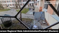 People clear broken glass after Russian drones hit a hospital in Stepanivka in the Kherson region, Ukraine, in this screengrab taken from a video released on Dec. 16, 2023. (Kherson Regional State Administration/Handout via Reuters)