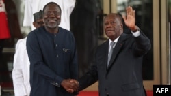FILE - ECOWAS President Omar Touray, left, greets Ivory Coast President Alassane Ouattara at the ECOWAS emergency summit on the coup in Niger on Aug. 10, 2023, in Abuja, Nigeria.