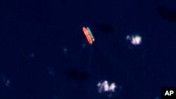 FILE - Vessels identified as the Virgo, left, and the Suez Rajan by the advocacy group United Against Nuclear Iran are seen in the South China Sea on Feb. 13, 2022, in this satellite photo provided by Planet Labs PBC. 