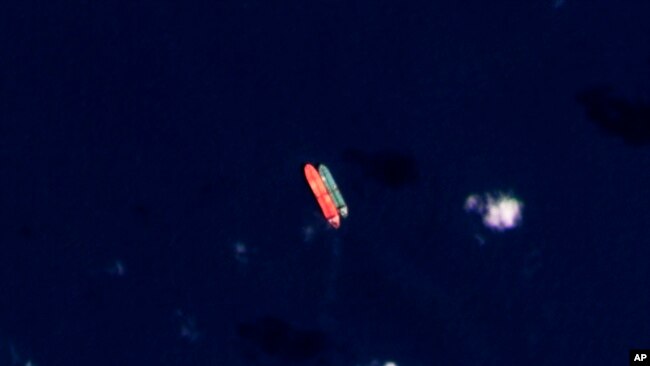 FILE - In this satellite photo provided by Planet Labs PBC, vessels identified as the Virgo, left, and the Suez Rajan by the advocacy group United Against Nuclear Iran are seen in the South China Sea on Feb. 13, 2022. 