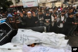 Palestinians pray for people killed in the Israeli bombardment of the Gaza Strip in Rafah, Dec. 13, 2023.