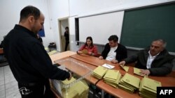 Election officials count ballots at a polling station in Istanbul on May 14, 2023, after polls closed in Turkey's presidential and parliamentary elections.