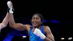 Refugee Olympic Team's Cindy Ngamba celebrates after defeating Canada's Tammara Thibeault in the women's 75 kg preliminary boxing match at the 2024 Summer Olympics, in Paris, France, July 31, 2024.