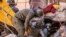Rescue workers search for survivors in a collapsed house in Moulay Brahim, Al Haouz province, Morocco, after an earthquake, Sept. 9, 2023.