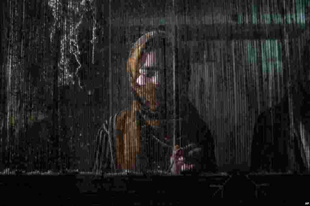 An Afghan woman weaves a carpet at a traditional carpet factory in Kabul.