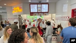 Customers queue up to order at an In-N-Out restaurant Sunday, June 2, 2024, in Lone Tree, Colo. On Wednesday, June 12, 2024, the Labor Department issues its report on prices at the consumer level in May. 