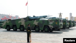 FILE - Military vehicles carrying hypersonic missiles drive past Tiananmen Square during the military parade marking the 70th founding anniversary of People's Republic of China, on its National Day in Beijing, Oct. 1, 2019.