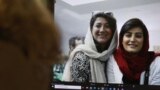 FILE - A woman looks at a computer screen with a photo of Iranian journalists Niloofar Hamedi and Elaheh Mohammadi, in Nicosia, Cyprus, Nov. 2, 2022. 