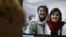 FILE - A woman looks at a computer screen with a photo of Iranian journalists Niloofar Hamedi and Elaheh Mohammadi, in Nicosia, Cyprus, Nov. 2, 2022. 