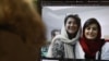 FILE - A woman looks at a computer screen with a photo of Iranian journalists Niloufar Hamedi, left, and Elaheh Mohammadi, right, in Nicosia, Cyprus, Nov. 2, 2022. 