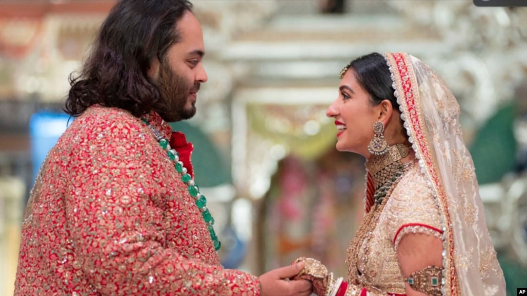 In this photo provided by Reliance Industries, Anant Ambani, son of billionaire Mukesh Ambani, holds hands with Radhika Merchant during their wedding ceremony at Jio World Convention Centre in Mumbai, India, July 12, 2024. 