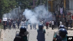 FILE - Students clash with riot police during a protest against a quota system for government jobs, in Dhaka, Bangladesh, July 18, 2024. Hasan Mehedi, a journalist for Dhaka Times, was killed July 18 in the Jatrabari district of Dhaka.