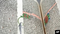 FILE - A detail of the Old Testament from the Gutenberg Bible on display at the personal library of Pierpont Morgan, the Morgan Library and Museum, in New York, May 19, 2008. Three times per year, a library curator turns the page.