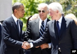 FILE - Then-President Barack Obama, then-Vice President Joe Biden and former President Bill Clinton attend a memorial service for the late Sen. Robert C. Byrd, D-W.Va., at the Capitol in Charleston, W.Va., July 2, 2010.