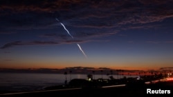 FILE: An evening launch of a SpaceX Falcon 9 rocket carrying 20 Starlink V2 Mini satellites, from Space Launch Complex at Vandenberg Space Force Base is seen over the Pacific Ocean from Encinitas, California, June 23, 2024. 