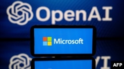 FILE - This illustration photo taken Jan. 23, 2023, shows screens displaying the logos of Microsoft and OpenAI.