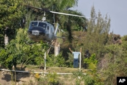 A helicopter lands to evacuate personnel at the Dominican Embassy in Port-au-Prince, Haiti, March 21, 2024.