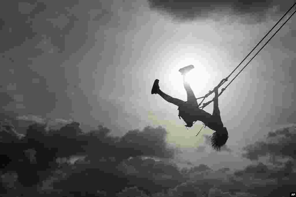 A woman swings on a swing in Venao beach in Pedasi, Panama, July 13, 2024. 