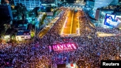 An aerial view shows people protesting as Israeli Prime Minister Benjamin Netanyahu's nationalist coalition government presses on with its contentious judicial overhaul, in Tel Aviv, Israel, March 18, 2023.