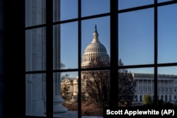 FILE - The U.S. Capitol is seen through a window in the Russell Senate Office Building, March 15, 2023. (AP Photo/J. Scott Applewhite)