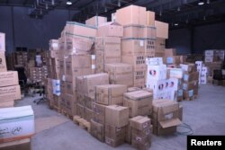 FILE - Boxes containing aid are stockpiled in a warehouses run by Sudan Humanitarian Aid Commission, following the crisis in Sudan's capital Khartoum, at the city of Port Sudan, Sudan, May 30, 2023.