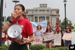 FILE - West Virginia University senior Mailyn Sadler leads a protest in the university's free speech zone outside the Mountainlair student union against cuts to programs, Aug. 21, 2023, in Morgantown, W.Va.