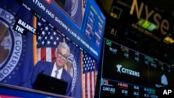 FILE - A screen displays a news conference with Federal Reserve Chairman Jerome Powell on the floor at the New York Stock Exchange in New York, May 1, 2024. On June 12, 2024, the Federal Reserve signaled it expects to cut its benchmark interest rate just once this year. 