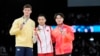 From left, silver medalist Illia Kovtun, of Ukraine, poses with gold medalist Zou Jingyuan, of China, and bronze medalist Shinnosuke Oka, right, of Japan, after the men's individual parallel bars finals at the Olympics, in Paris, France, Aug. 5, 2024. 