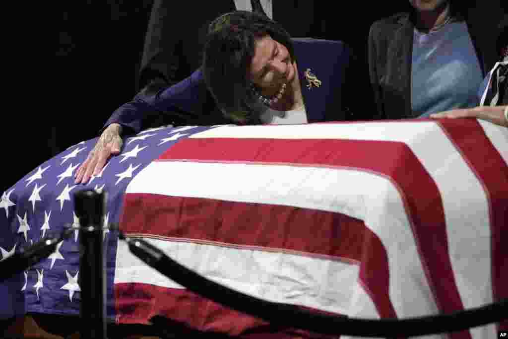 U.S. Rep. Nancy Pelosi, D-Calif., puts her arm around the casket of the late Sen. Dianne Feinstein at City Hall in San Francisco, California. (AP Photo/Godofredo A. Vásquez)