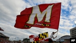 FILE - The Maryland state flag and University of Maryland flag are run across the end zone after a touchdown during the first half of an NCAA college football game against Indiana, Sept. 30, 2023, in College Park, Md.