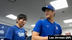 FILE - Los Angeles Dodgers' Shohei Ohtani, right, and his interpreter, Ippei Mizuhara, leave ahead of a baseball workout at Gocheok Sky Dome in Seoul, South Korea, March 16, 2024.