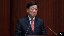FILE - Hong Kong Chief Executive John Lee delivers an address at the chamber of the Legislative Council in Hong Kong, on Oct. 19, 2022. Lee condemned an unusual rise in the number of withdrawal requests to the city’s organ donation system on May 23, 2023.