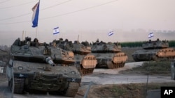 Israeli tanks head towards the Gaza Strip border in southern Israel on Thursday, Oct.12, 2023. 