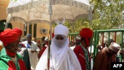 FILE—The Emir of Kano Muhammadu Sanusi II (C) arrives to attend the mass wedding of 1,520 couples at the city's central mosque on February 26, 2017. 