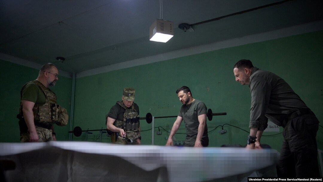Ukraine's President Volodymyr Zelenskiy listens a report of Commander of the Ground Forces colonel general Oleksandr Syrskyi at a position near the front line in Donetsk region, June 26, 2023. 