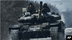 Ukrainian soldiers ride atop a tank on the front line in Bakhmut, Donetsk region, Ukraine, Feb. 20, 2023. On Feb. 24, 2023, it was reported that Moscow’s forces had made progress trying to encircle Bakhmut.