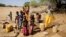 FILE - Children fetch water in a well dug amid a drought in Kinya village, Samburu county, Kenya, Oct. 13, 2022.